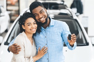 Couple smiling with keys in hand